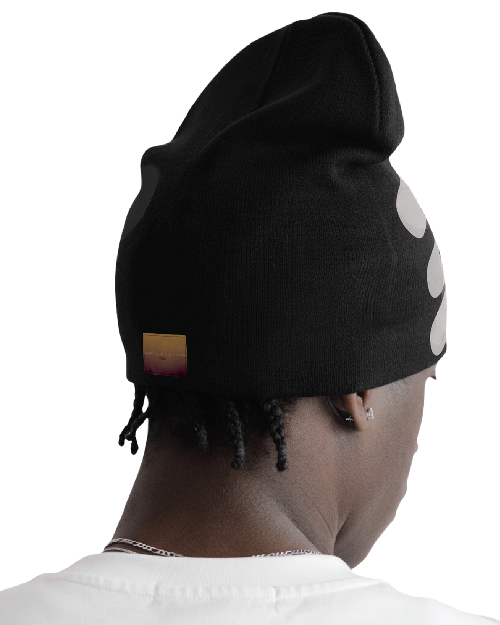 Person wearing a black beanie with white polka dots on a white background