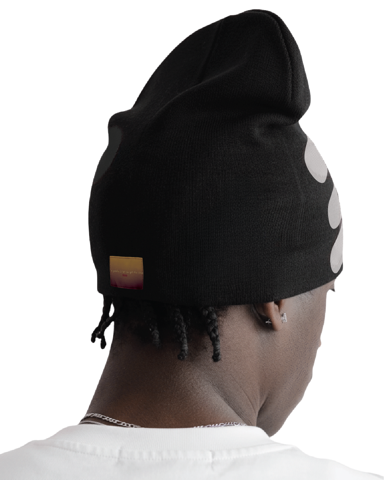 Person wearing a black beanie with white polka dots on a white background